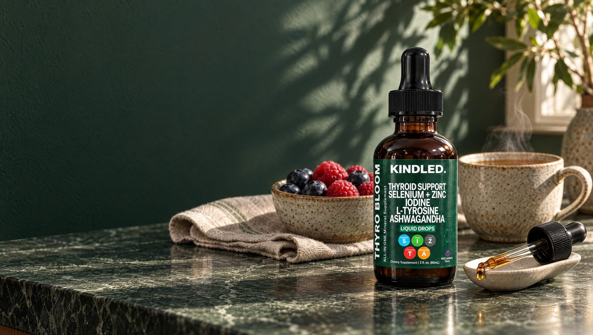 Kindled thyroid support drops on a green marble counter with berries and tea in morning light